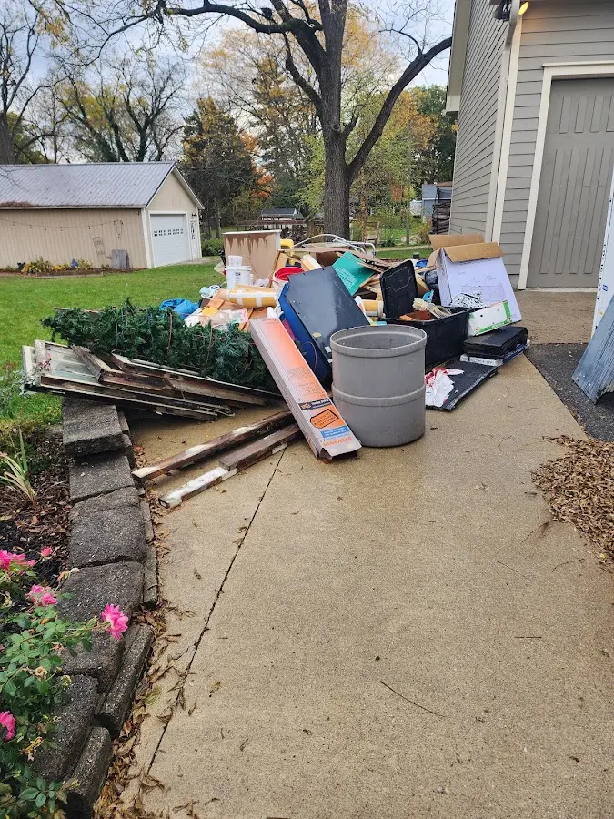Dumpster being loaded with debris for Roofing Dumpster Rental in Sunnyside